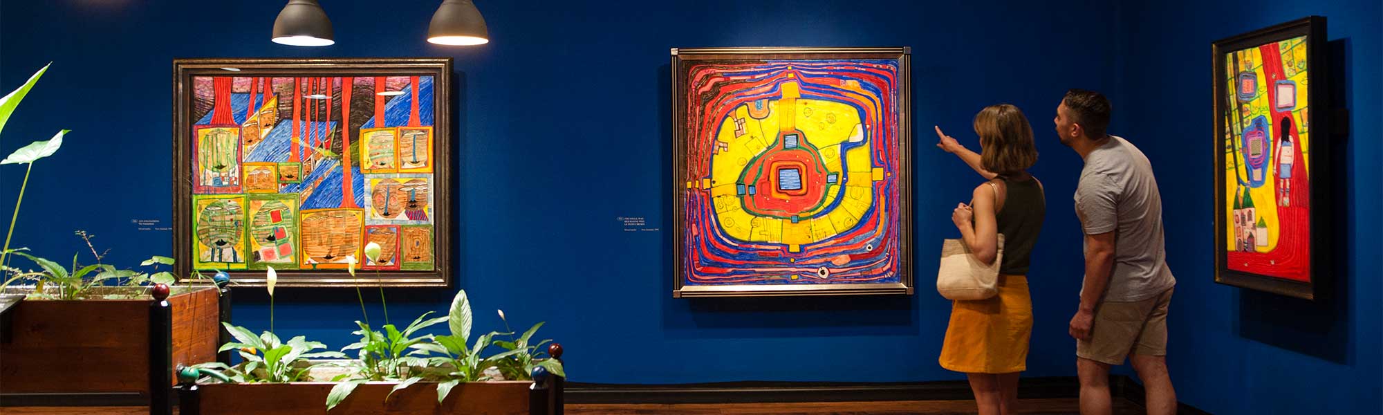 A couple looking at artworks by Hundertwasser 