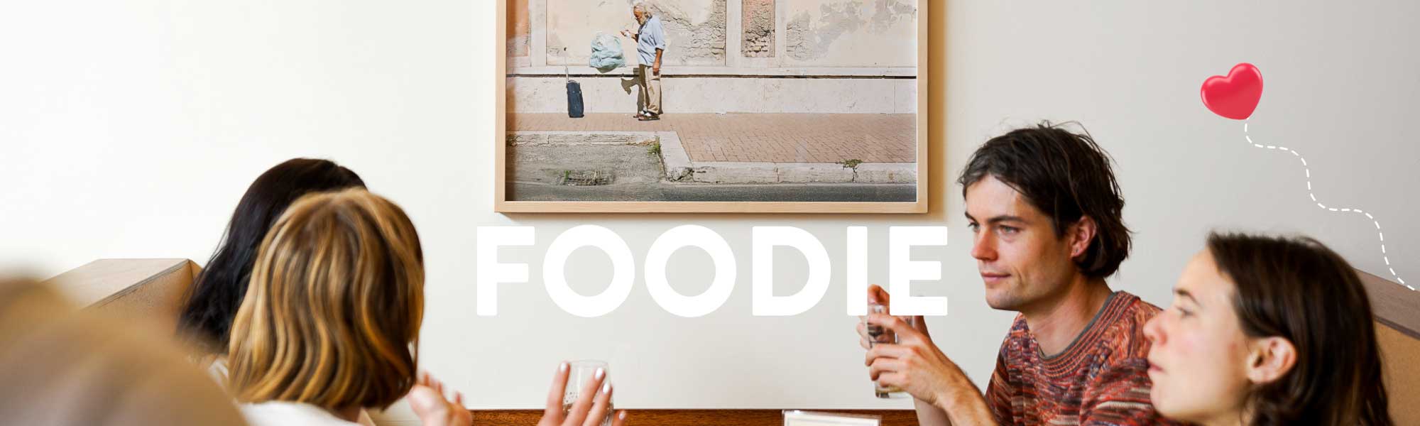 People talking in a restaurant with the word FOODIE above