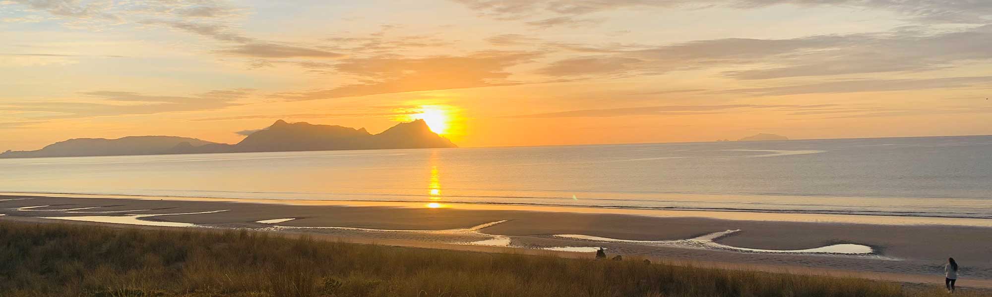 Sunrise over Whangarei Heads, from Ruakaka Beach